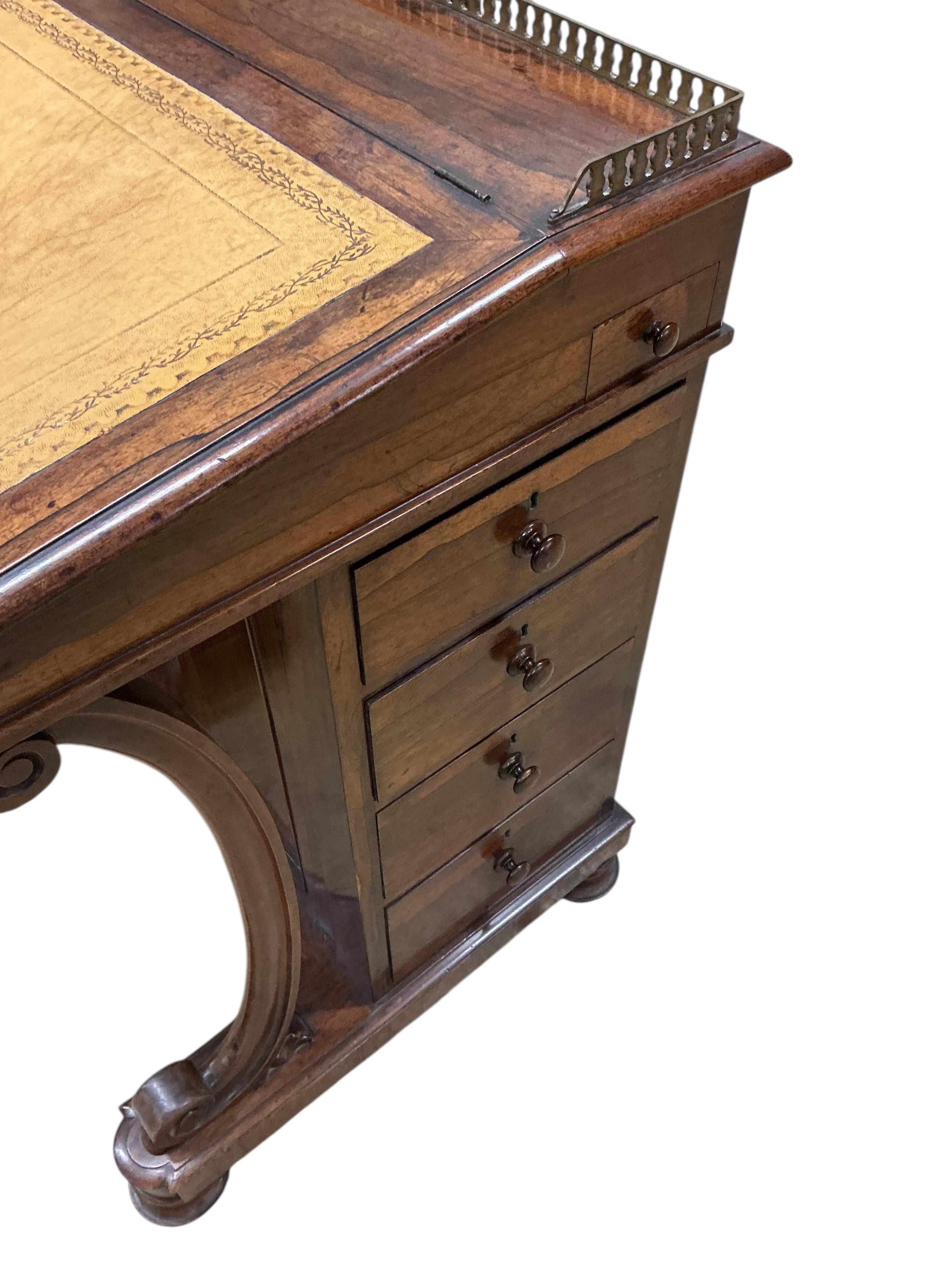 An early Victorian rosewood Davenport, width 60cm, depth 54cm, height 83cm